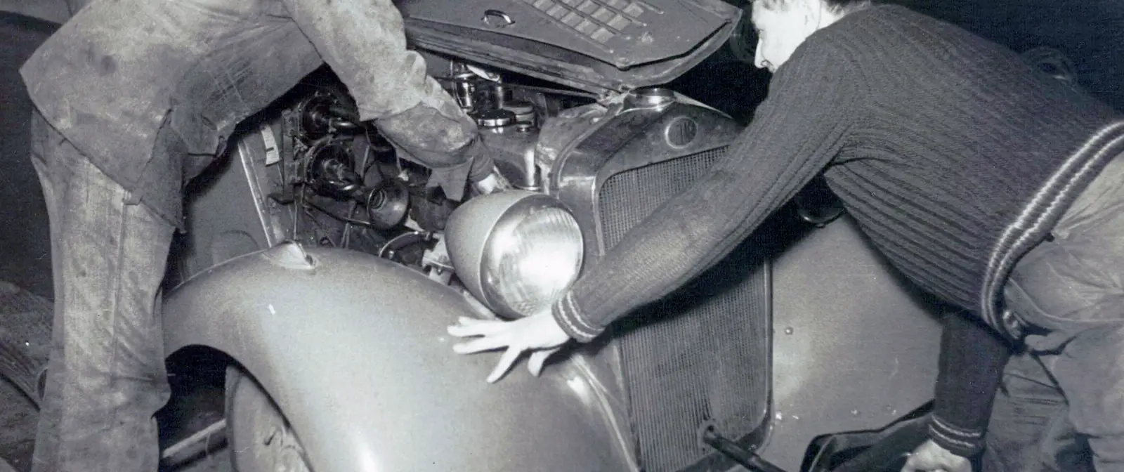 Deux mécaniciens au travail sur un moteur au Garage Luthringer dans les années 1950